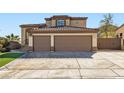 Image showing the home's three-car garage, concrete driveway, and desert landscaping at 767 Durgos Dr, Henderson, NV 89012