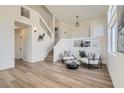 Bright living room with wood floors, stairs, and modern furniture at 767 Durgos Dr, Henderson, NV 89012