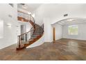 Grand foyer showcasing a curved staircase and elegant tile flooring at 7840 Red Leaf Dr, Las Vegas, NV 89131