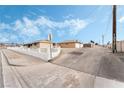 Street view showcasing the home's architecture and neighborhood charm under a blue and cloudy sky at 845 Palo Verde Dr, Henderson, NV 89015