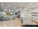 Bright open-plan living room and kitchen featuring a white kitchen island, tile floors and a view to the outdoors at 9101 Alta Dr # 103, Las Vegas, NV 89145