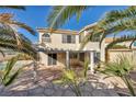 Inviting covered patio space overlooking a private backyard oasis with mature trees and a pool at 1 Rising Sun Ct, Henderson, NV 89074