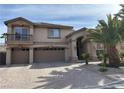 Two-story home with a three-car garage and desert landscaping at 11118 Scotscraig Ct, Las Vegas, NV 89141