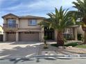 Two-story home with a three-car garage, a small balcony, and desert landscaping at 11118 Scotscraig Ct, Las Vegas, NV 89141