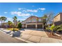 Inviting two-story home with a three-car garage and manicured front lawn at 2241 Verde Cape Ave, Henderson, NV 89052