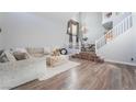 Spacious living room featuring hardwood floors, staircase, and modern decor at 2241 Verde Cape Ave, Henderson, NV 89052