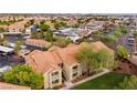 An aerial view of the complex shows well manicured landscaping, mature trees, and the layout of the apartment units at 2300 E Silverado Ranch Blvd # 2040, Las Vegas, NV 89183