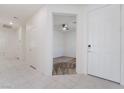 Bright entryway with white tile flooring, leading to a carpeted room with ceiling fan at 2910 Ventana Ridge Ave, Henderson, NV 89044