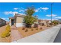 Inviting single-story home with brick walkway, desert landscaping, and a charming front door at 2910 Ventana Ridge Ave, Henderson, NV 89044