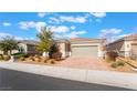 Charming single-story home featuring desert landscaping, a brick driveway, and a two-car garage at 2910 Ventana Ridge Ave, Henderson, NV 89044