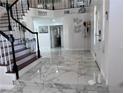 Spacious foyer with marble floors, staircase with wood treads, and a welcoming atmosphere at 2913 Domino Way, Las Vegas, NV 89117