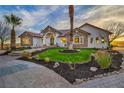 Stunning single-story home with lush landscaping and a circular driveway leading to the grand entrance at 2925 Hidden Hollow Cir, Logandale, NV 89021