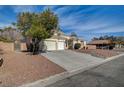 Single-story home with three-car garage and low-maintenance landscaping for a clean, desert aesthetic at 344 E Rush Ave, Las Vegas, NV 89183