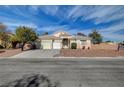 Charming single-story home with a well-maintained lawn and a spacious three-car garage at 344 E Rush Ave, Las Vegas, NV 89183