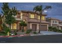 Inviting two-story stucco home features a two-car garage, desert landscaping, and a classic tile roof at 4664 Stuttgart St, Las Vegas, NV 89147