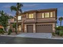 An inviting two-story stucco home features a two-car garage, desert landscaping, and a classic tile roof at 4664 Stuttgart St, Las Vegas, NV 89147