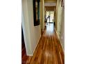 Hallway with wood floors leading to the backyard at 5705 Petrified Tree Ln, North Las Vegas, NV 89081