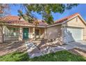 Single-story home featuring a 2-car garage, tile roof, mature tree, and well-maintained lawn and landscaping at 7021 Feather Pine St, Las Vegas, NV 89131