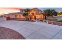 Large house with a long driveway, an arched entrance with red double doors and well-maintained landscaping at 7771 Pleasant Slopes Ct, Las Vegas, NV 89131