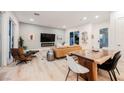 Open concept living space with modern furnishings, hardwood floors, and large windows for natural light at 800 Loch Katrine Ave, Henderson, NV 89012
