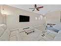 Relaxing living room with large screen television and a white leather sectional at 9413 Aggie Ct, Las Vegas, NV 89148