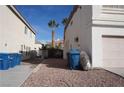 View of the side yard with tan exterior of home, showcasing the side gate access at 10228 W Crepe Myrtle Ct, Las Vegas, NV 89183