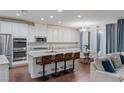 Open-concept kitchen with stainless steel appliances, large island, and adjacent dining area at 12382 Piazzo St, Las Vegas, NV 89141