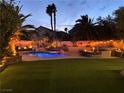Backyard oasis with a large pool, water features, slide and built in BBQ with bar seating at 1705 Pink Cliff Ct, Las Vegas, NV 89128