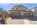 The attached two-car garage provides ample parking and convenience with a paved driveway at 1803 Potosi Peak Ave, North Las Vegas, NV 89031