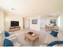 Open living room showing the dining area, light colored furniture, and neutral walls at 1912 W Carey Ave, North Las Vegas, NV 89032