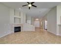 Living room with open layout, fireplace, tile floors and view to the front entry at 3412 Amish Ave, North Las Vegas, NV 89031