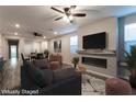 Comfortable living area featuring stylish furniture, a modern fireplace, and a wall-mounted TV at 361 Black Turnstone Ct, Las Vegas, NV 89138