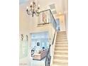 Inviting foyer with staircase and view to living area at 3999 Delos Dr, Las Vegas, NV 89103