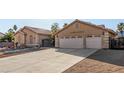 Home's front exterior features large two-car garage, decorative window and iron gate at 4245 N Campbell Rd, Las Vegas, NV 89129