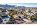 Desert home in suburban neighborhood features a private pool, mature landscaping, and mountain views at 4245 N Campbell Rd, Las Vegas, NV 89129