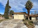 Attached two-car garage with manicured landscaping at 4530 W Maulding Ave, Las Vegas, NV 89139