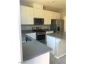 Modern kitchen featuring stainless steel appliances, granite countertops, and white cabinetry at 5392 Blustery Towns Ave, Las Vegas, NV 89118