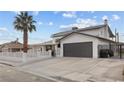 Beautiful two-story home with lush landscaping, a two-car garage, and inviting curb appeal at 638 Paloma Dr, Boulder City, NV 89005