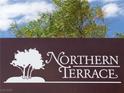 Close-up of the 'Northern Terrace' community sign with a tree graphic against a partly cloudy sky at 7735 Sugarloaf Peak St, Las Vegas, NV 89166