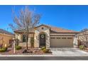 Charming single-story home with desert landscaping, a tile roof, and an inviting arched entryway at 7735 Sugarloaf Peak St, Las Vegas, NV 89166