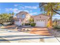 Charming two-story home featuring a well-maintained yard, a tile roof, and a two-car garage at 8225 Taos Paseo Ave, Las Vegas, NV 89128