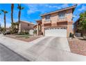 Home with tan exterior, tile roof, two car garage, and desert landscaping at 8348 Brittany Harbor Dr, Las Vegas, NV 89128