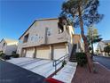 Attractive two-story townhome showcasing attached garages and private stairway access at 2152 Turquoise Ridge St # 207, Las Vegas, NV 89117
