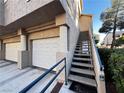 Close up view of a townhome's garage doors with direct access to a private stairway at 2152 Turquoise Ridge St # 207, Las Vegas, NV 89117
