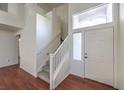 Bright entryway showcasing stairs with white banisters and wood-look flooring at 2180 Maple Shade St, Henderson, NV 89002