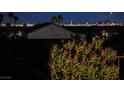 City view from the backyard with palm trees in silhouette at 2720 Spalding Dr, Las Vegas, NV 89134