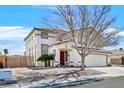 Two-story home showcasing a red front door, desert landscaping, and an attached two-car garage at 3400 Crystal Tower St, Las Vegas, NV 89129