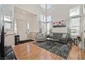 Bright living room with high ceilings, lots of natural light, wood floors, and modern furnishings at 3400 Crystal Tower St, Las Vegas, NV 89129