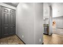 View of a home entryway showcasing tile floors, neutral paint, and stainless steel appliances at 344 Tuscany Cir, Mesquite, NV 89027