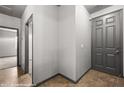 View of a hallway featuring a grey front door, tile floors, and neutral paint at 344 Tuscany Cir, Mesquite, NV 89027